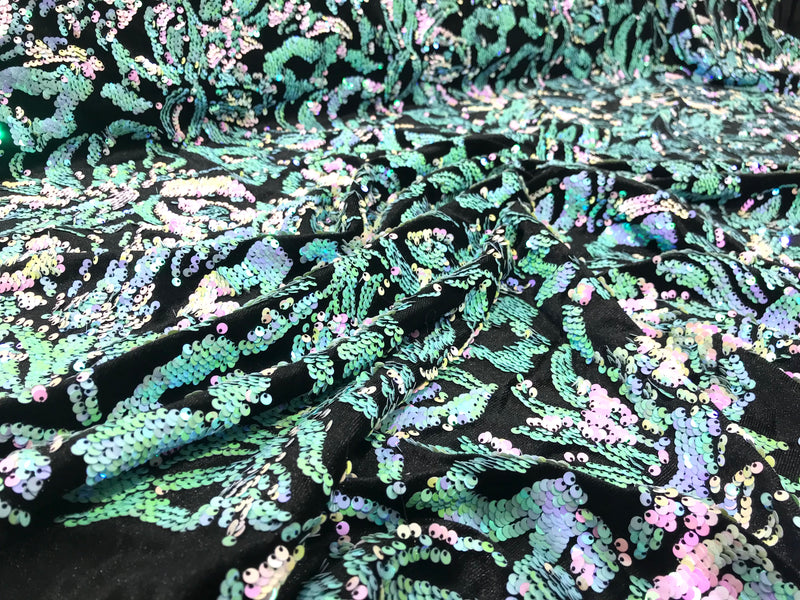 Mint iridescent, pink sequins flip two tone floral design on a black stretch velvet, Sold by the yard.
