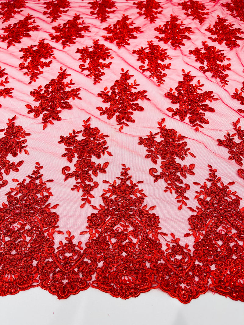 Red floral design embroidery on a mesh lace with sequins and cord-sold by the yard.