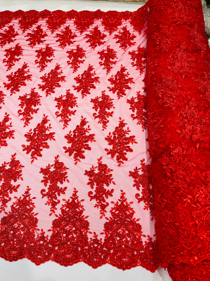 Red floral design embroidery on a mesh lace with sequins and cord-sold by the yard.