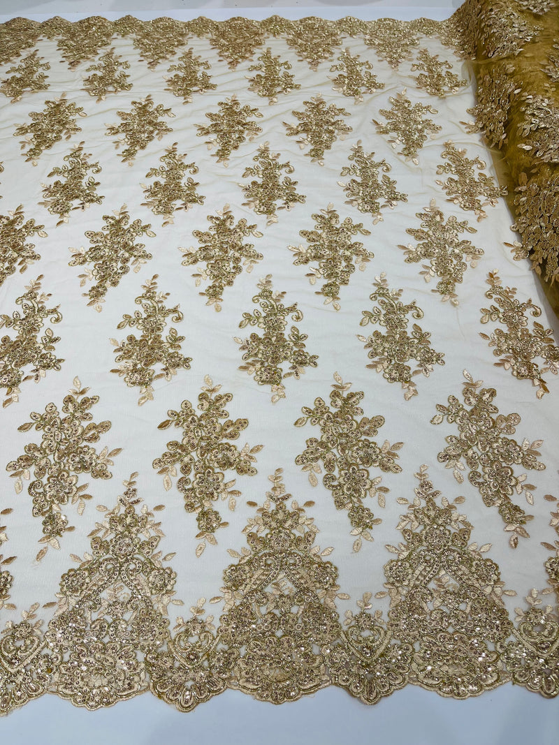 Champagne metallic floral design embroidery on a mesh lace with sequins and cord-sold by the yard.