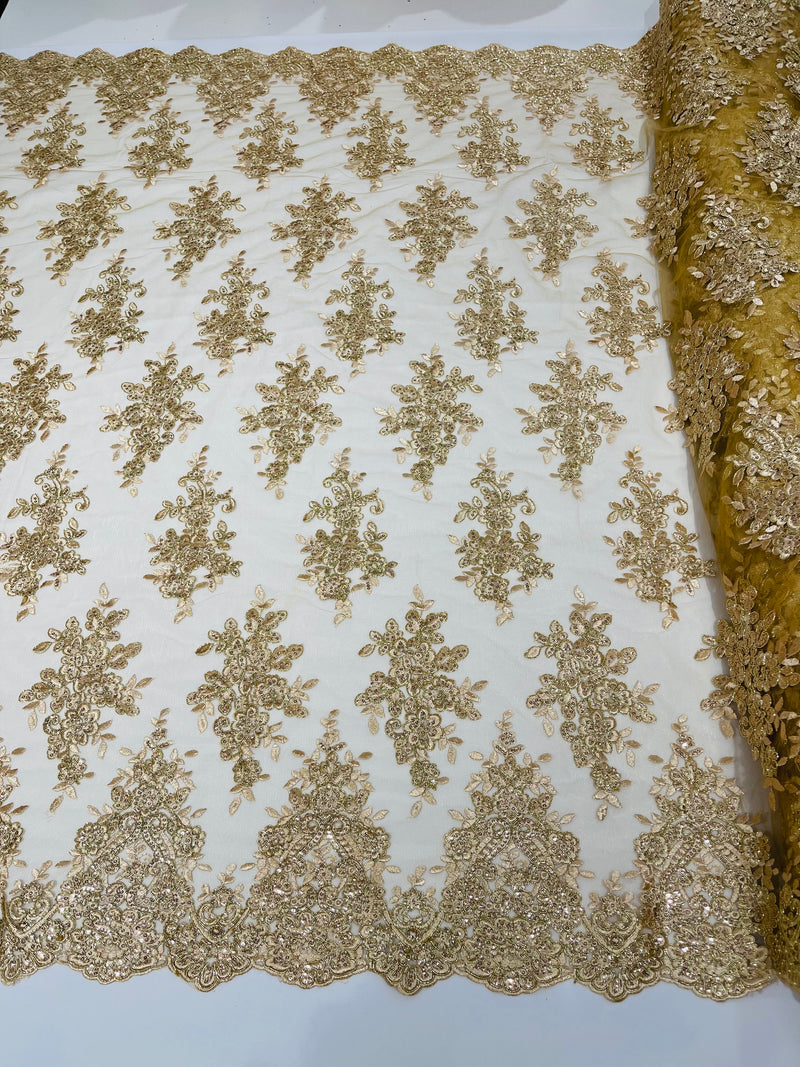 Champagne metallic floral design embroidery on a mesh lace with sequins and cord-sold by the yard.