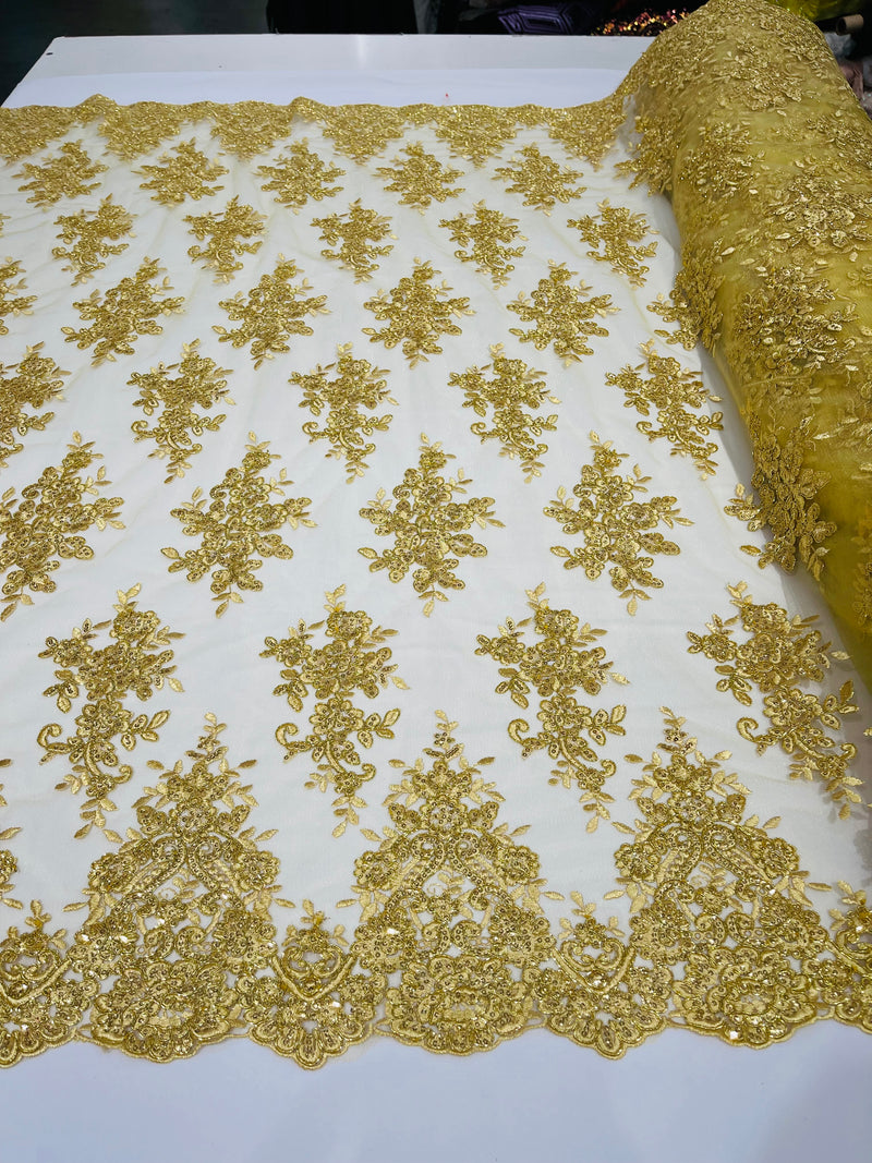 Gold Metallic floral design embroidery on a mesh lace with sequins and cord-sold by the yard.