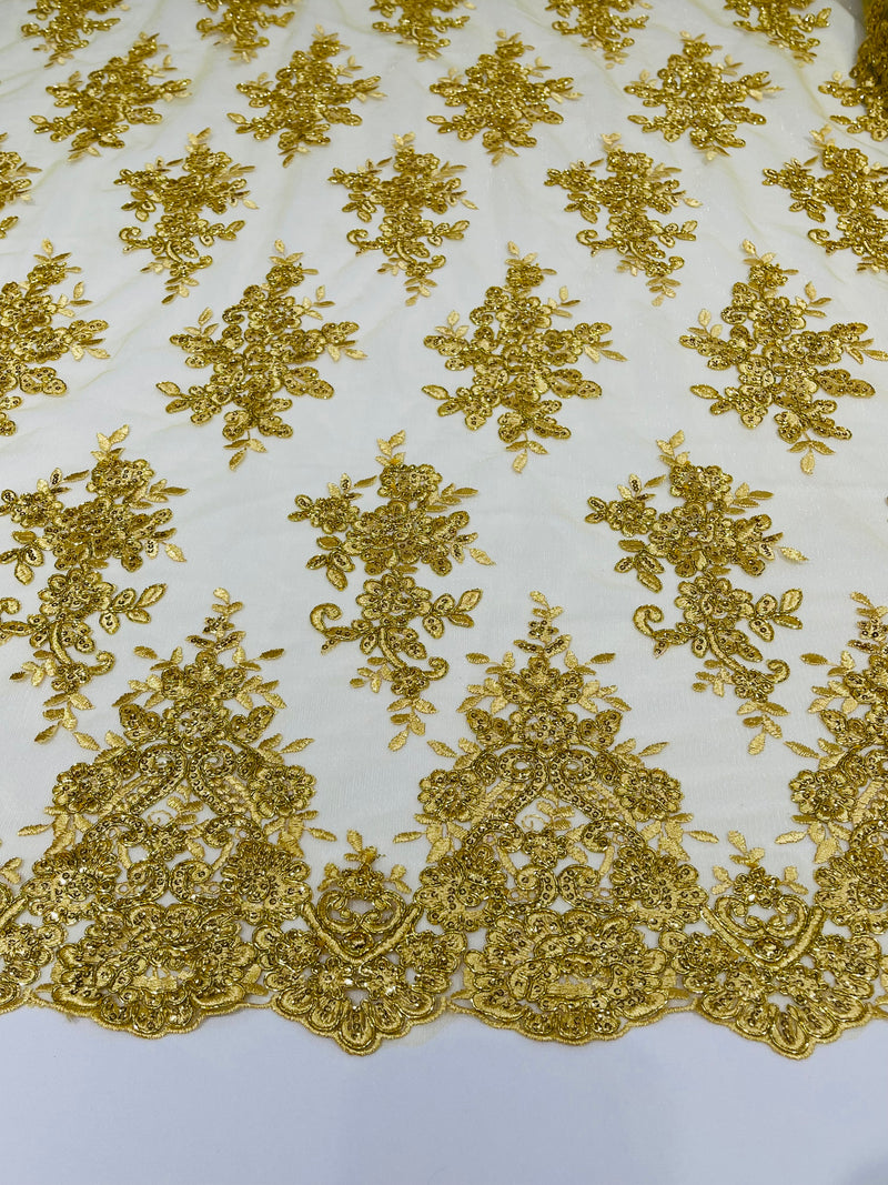 Gold Metallic floral design embroidery on a mesh lace with sequins and cord-sold by the yard.