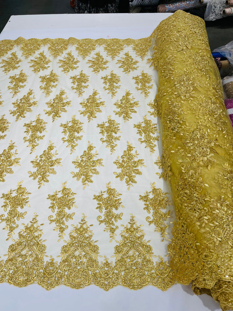 Gold Metallic floral design embroidery on a mesh lace with sequins and cord-sold by the yard.