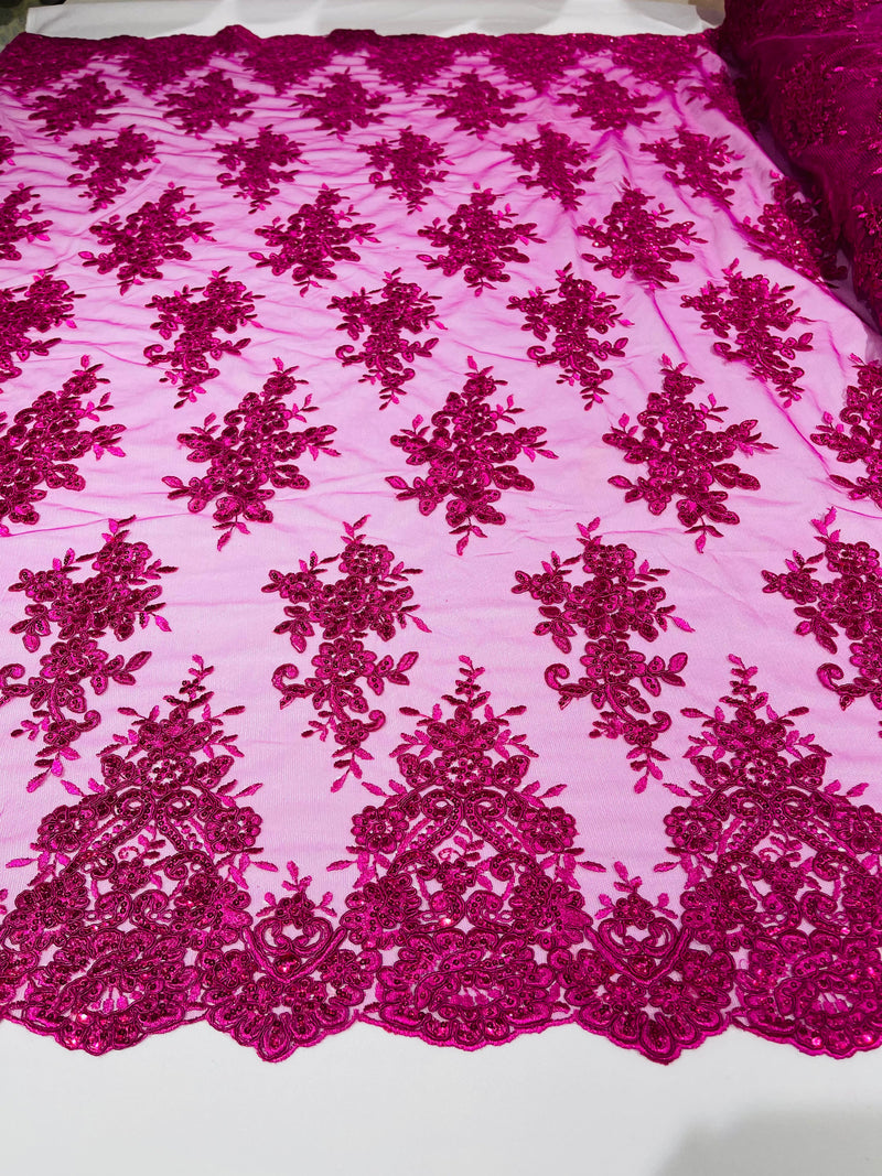 Fuchsia floral design embroidery on a mesh lace with sequins and cord-sold by the yard.