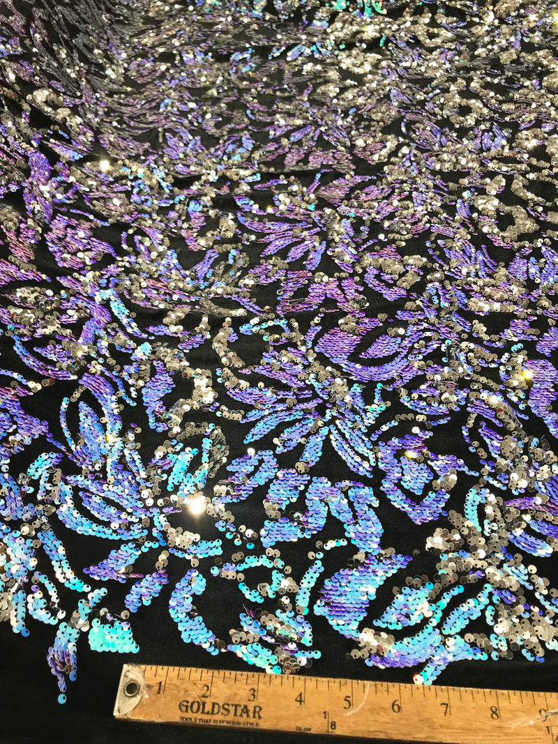 Aqua iridescent, silver sequins flip two tone floral design on a black stretch velvet, Sold by the yard.