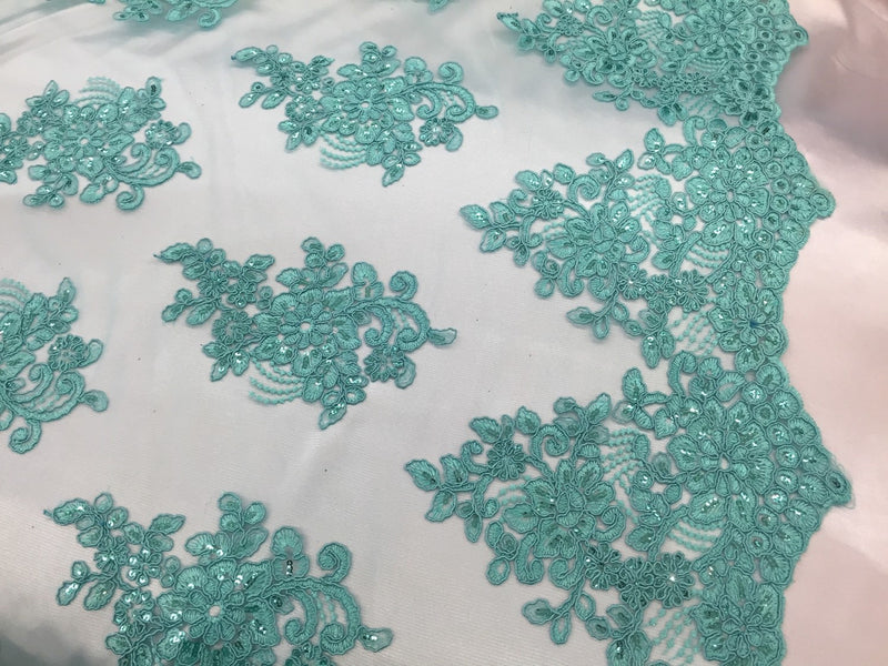 Aqua flower lace corded and embroider with sequins on a mesh. Wedding/bridal/prom/nightgown fabric. Sold by the yard.