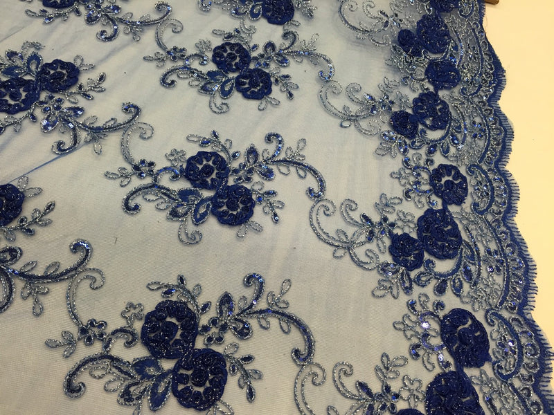 Royal blue 3d flowers embroider with sequins on a mesh lace fabric. Sold by the yard.