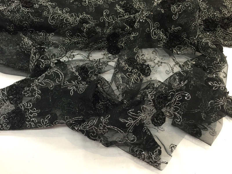 Black/silver  3d flowers embroider with sequins on a mesh lace fabric. Sold by the yard.