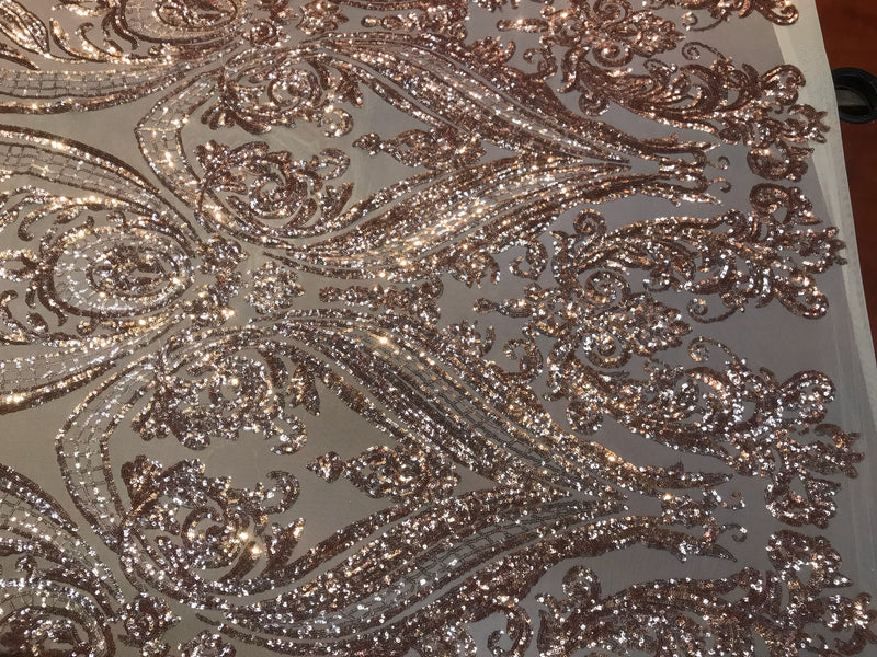 Rose gold empire design embroidered with shiny sequins on a 4 way Stretch Mesh-sold by the yard.