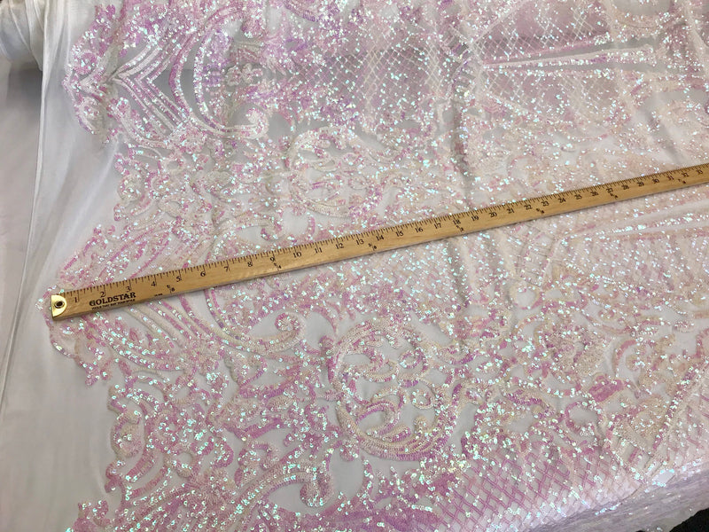 Pink princess design iridescent sequins on a 4 way stretch white mesh-sold by the yard.