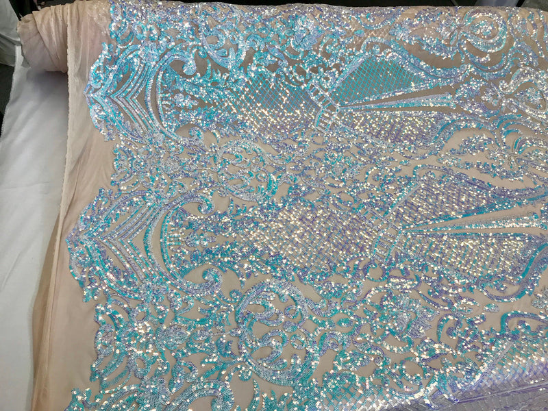 Aqua princess design iridescent sequins embroidery on a 4 way stretch nude mesh-sold by the yard.