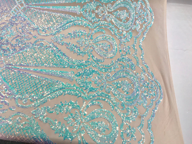 Aqua princess design iridescent sequins embroidery on a 4 way stretch nude mesh-sold by the yard.