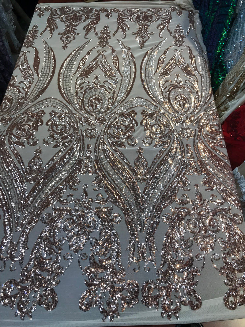 Rose gold empire design embroidered with shiny sequins on a 4 way Stretch Mesh-sold by the yard.