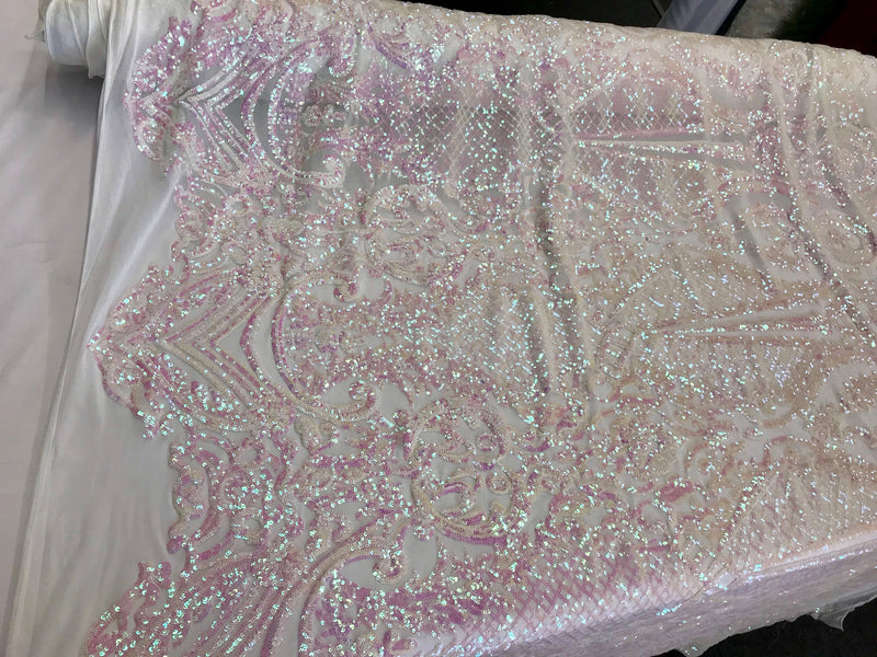 Pink princess design iridescent sequins on a 4 way stretch white mesh-sold by the yard.