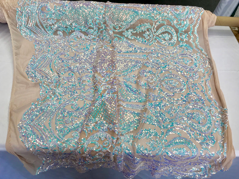 Aqua princess design iridescent sequins embroidery on a 4 way stretch nude mesh-sold by the yard.