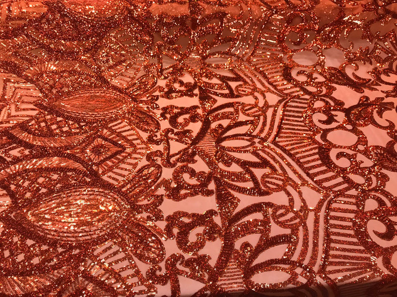 Burnt orange iridescent shiny sequin royalty design on a 4 way stretch mesh-sold by the yard.