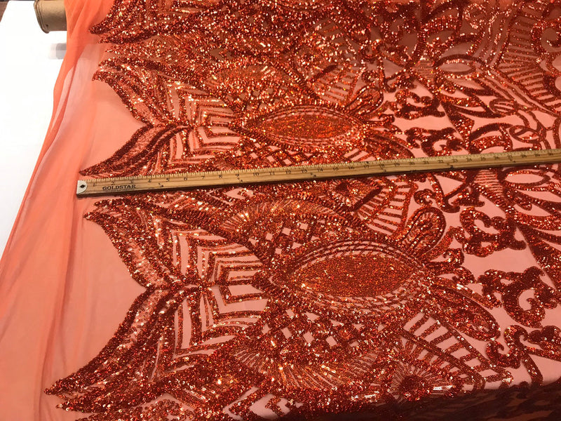 Burnt orange iridescent shiny sequin royalty design on a 4 way stretch mesh-sold by the yard.