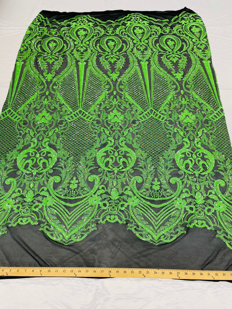 Neon green princess design iridescent sequins on a 4 way stretch black mesh-sold by the yard.