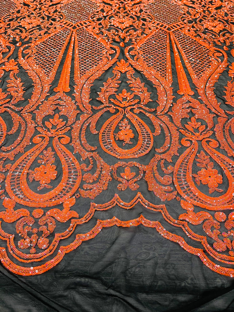 Neon orange princess design iridescent sequins on a 4 way stretch black mesh-sold by the yard.