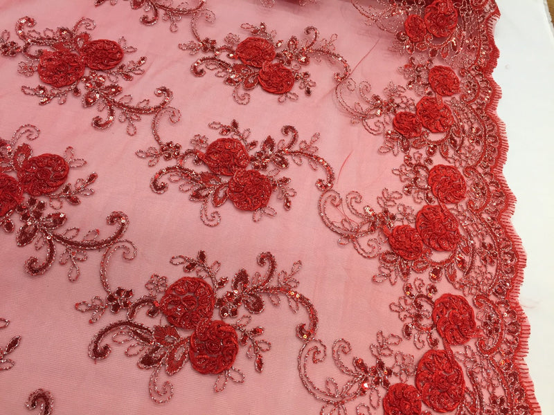 Red/silver  3d flowers embroider with sequins on a mesh lace fabric. Sold by the yard.