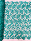 Estrella corded flowers embroider with sequins on a mesh lace fabric-sold by the yard.