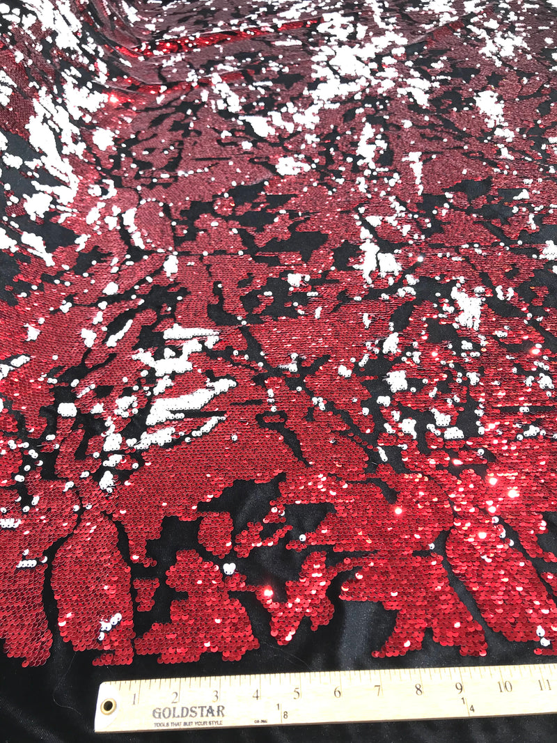 Camouflage flip sequin design on a black stretch velvet, Sold by the yard.