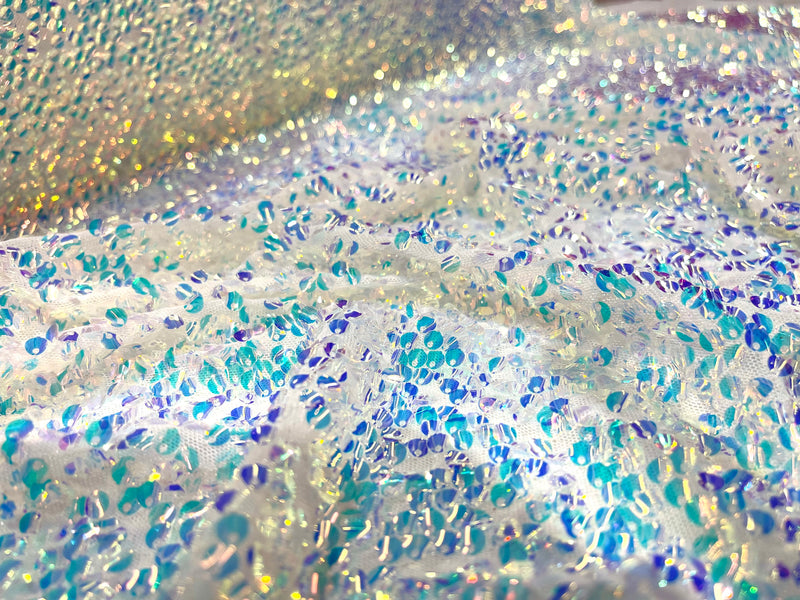 Aqua Clear iridescent mini round paillette sequins on a white stretch mesh, sold by the yard.