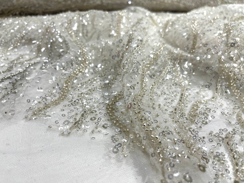 Off White heavy hand beaded design embroider with beads-pearls-sequins on a mesh lace-sold by yard.