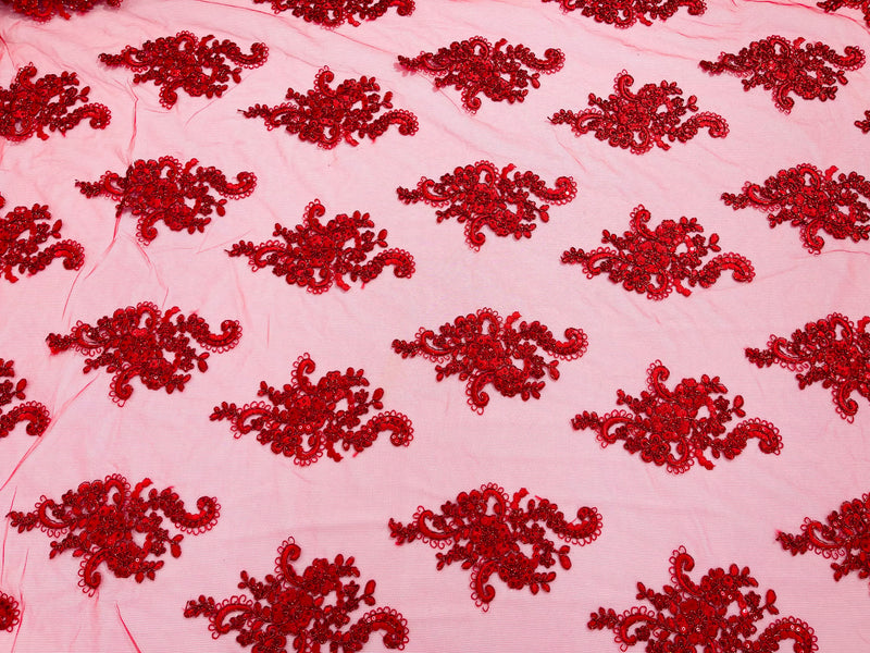 Red metallic floral design embroidery on a mesh lace with sequins and cord-sold by the yard.