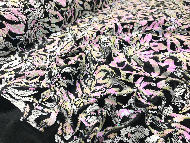 Pink, white iridescent sequins flip two tone floral design on a black stretch velvet, Sold by the yard.