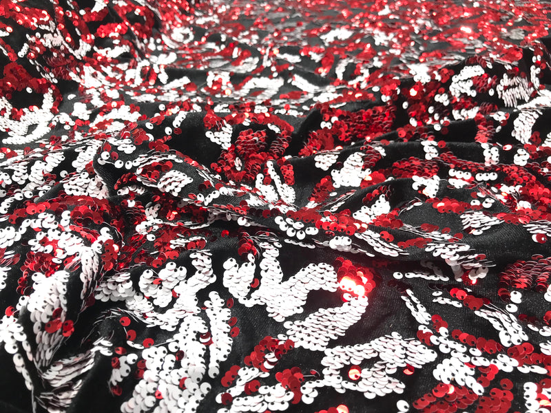 Red, white sequins flip two tone floral design on a black stretch velvet, Sold by the yard.