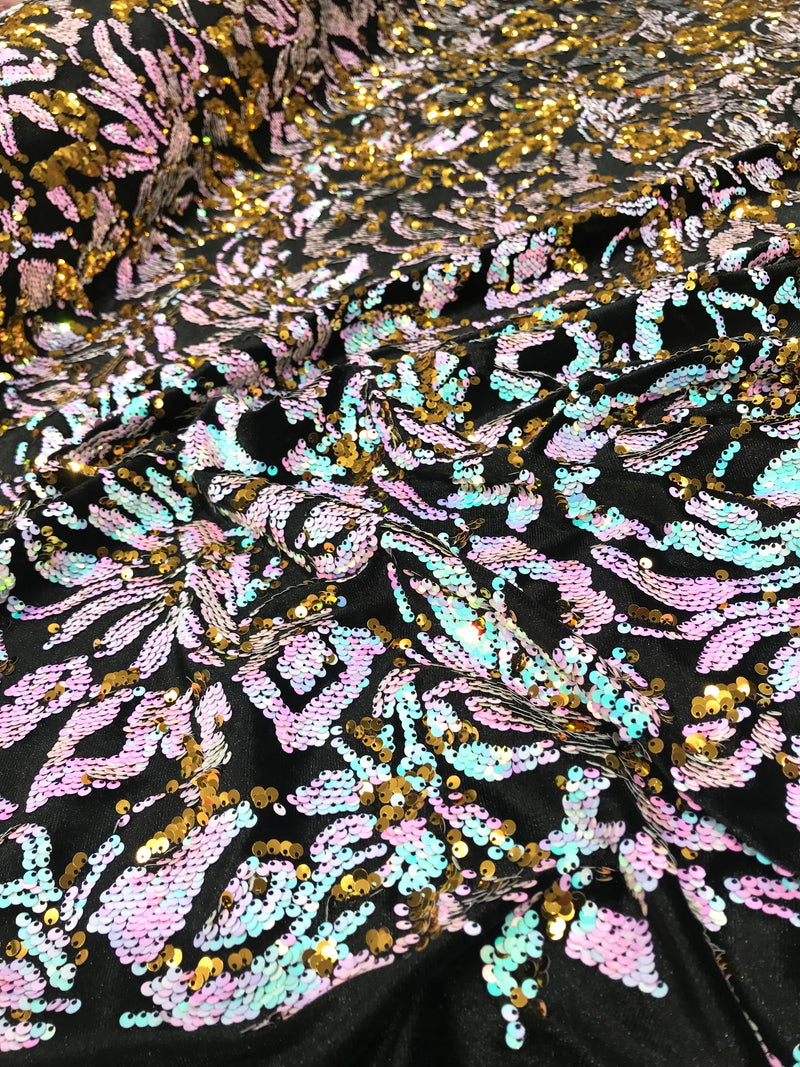 Aqua iridescent ,pink, gold  sequins flip two tone floral design on a black stretch velvet, Sold by the yard.