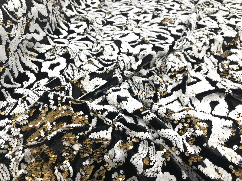 White/gold sequins flip two tone floral design on a black stretch velvet, Sold by the yard.